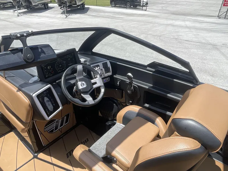 Slide: The Image of Interior of 2022 Malibu Wakesetter 23 LSV boat with modern dashboard and tan seating. - 23