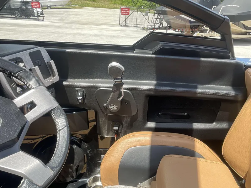 Slide: The Image of Interior view of 2022 Malibu Wakesetter 23 LSV boat, featuring steering wheel and dashboard controls. - 24