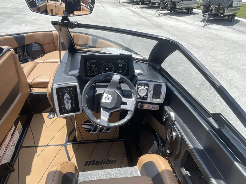 Slide: The Image of 2022 Malibu Wakesetter 23 LSV interior dashboard with steering wheel and digital controls. - 25