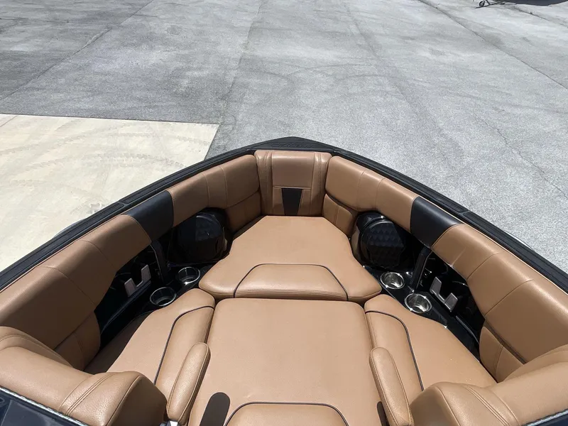 Slide: The Image of 2022 Malibu Wakesetter 23 LSV boat interior with tan leather seating and cup holders. - 28