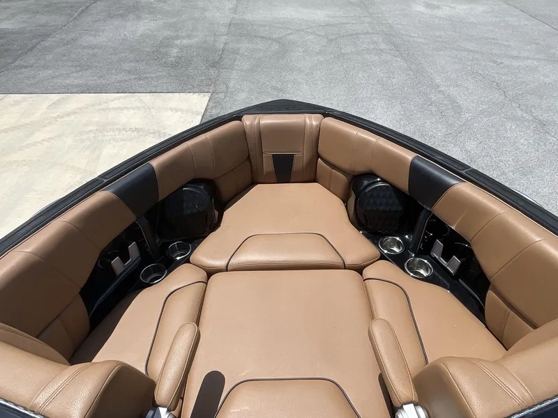 Slide: The Image of 2022 Malibu Wakesetter 23 LSV boat interior with tan leather seating and cup holders. - 29