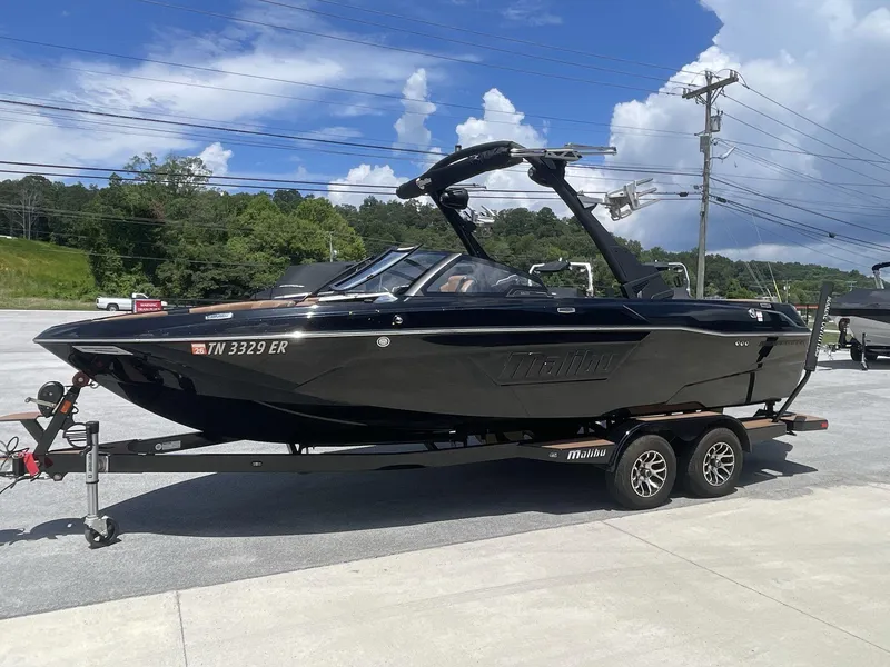 Slide: The Image of 2022 Malibu Wakesetter 23 LSV boat on trailer, parked outdoors under blue sky. - 3