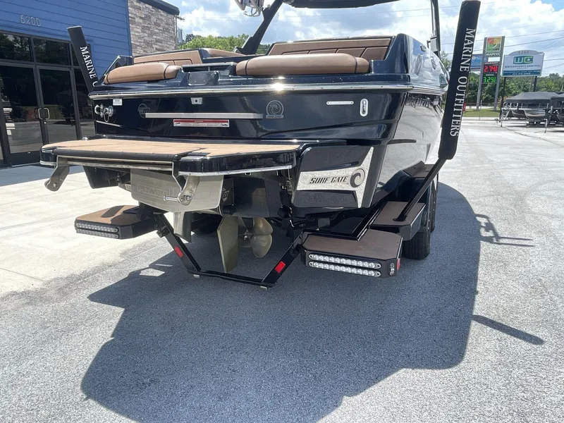 Slide: The Image of 2022 Malibu Wakesetter 23 LSV boat rear view, showcasing surf gate and propeller. - 7