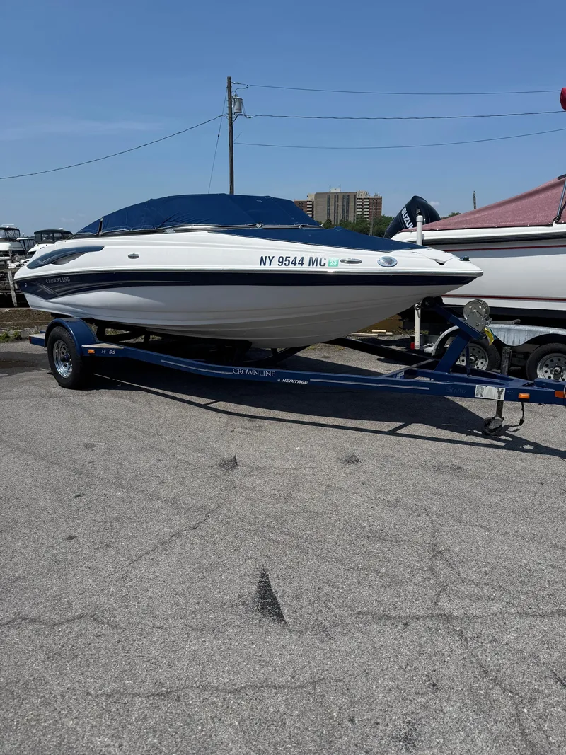 Slide: The Image of 2007 Crownline 19SS boat on trailer, parked outdoors under clear sky. - 2