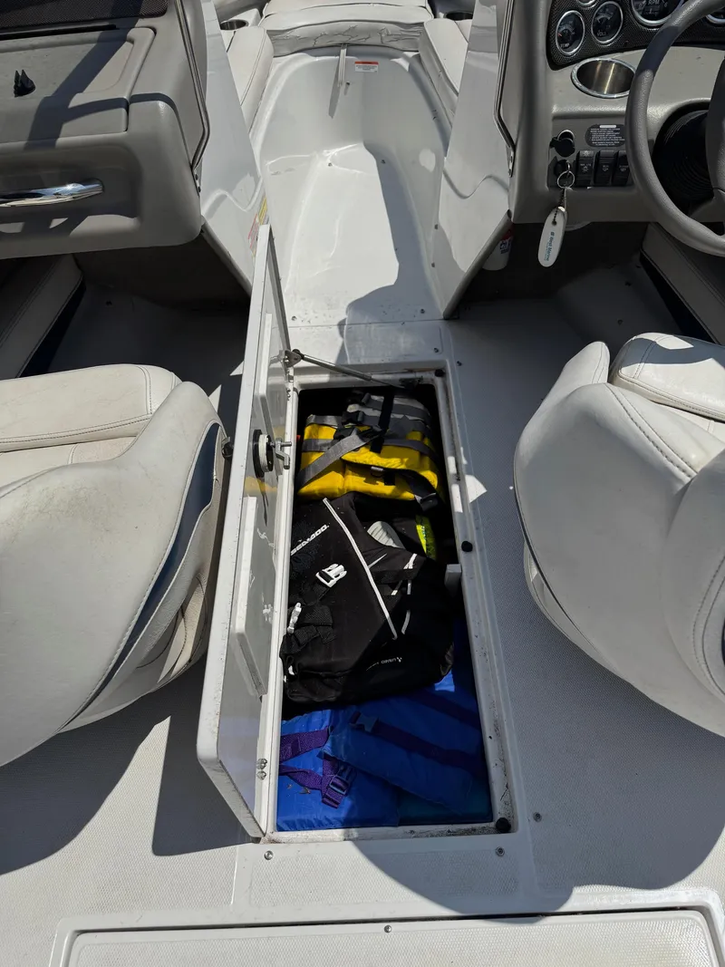 Slide: The Image of 2007 Crownline 19SS boat interior with open storage compartment containing life jackets. - 6