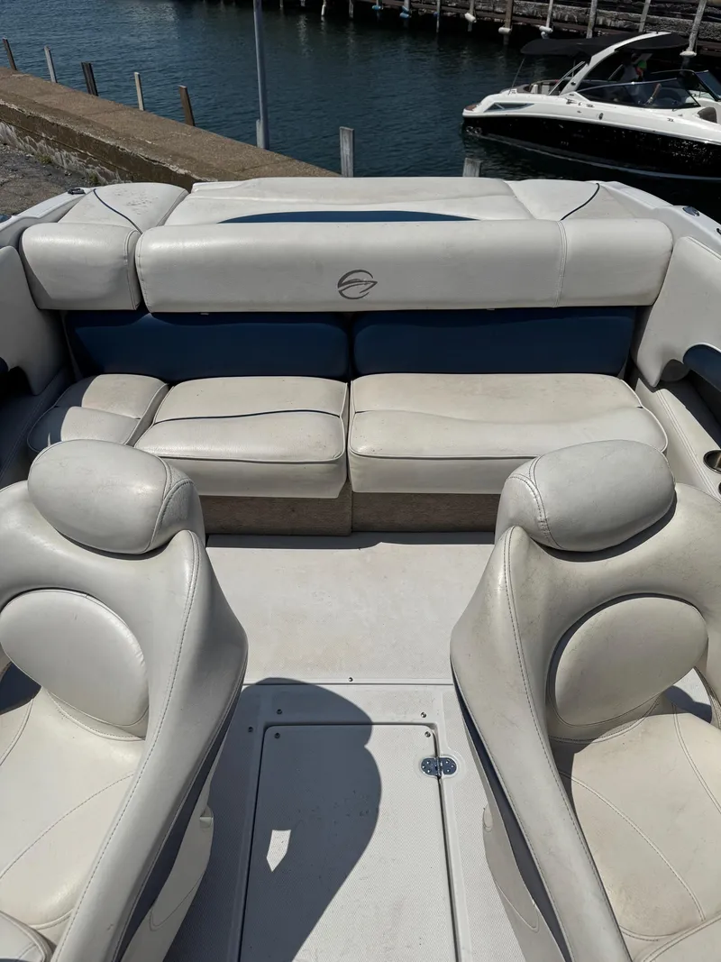 Slide: The Image of 2007 Crownline 19SS boat interior with white seating, docked by the water. - 8