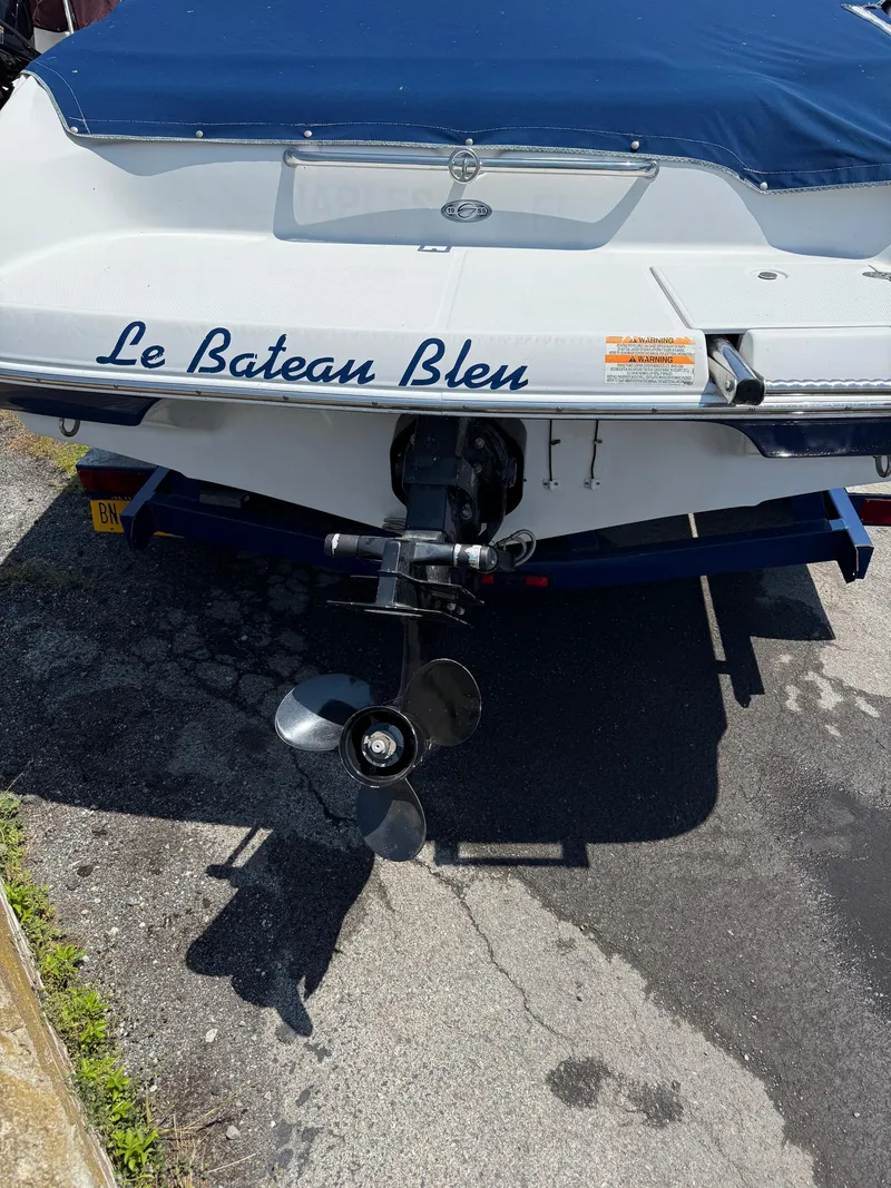 Slide: The Image of Rear view of 2007 Crownline 19SS boat named "Le Bateau Bleu" with blue cover. - 9
