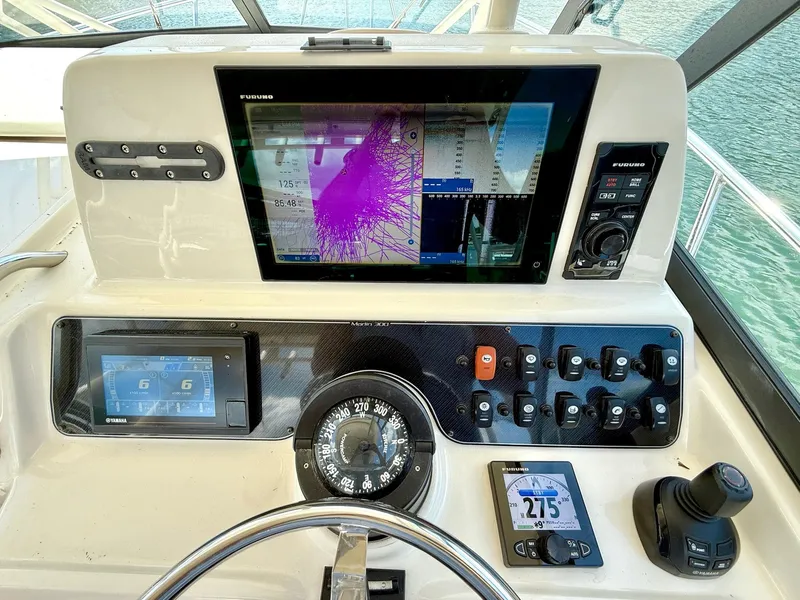 Slide: The Image of Control panel of a 2018 Grady-White Marlin 300 boat with navigation instruments. - 12
