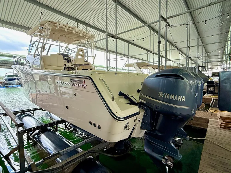 Slide: The Image of 2018 Grady-White Marlin 300 boat with Yamaha engines in covered dock. - 14