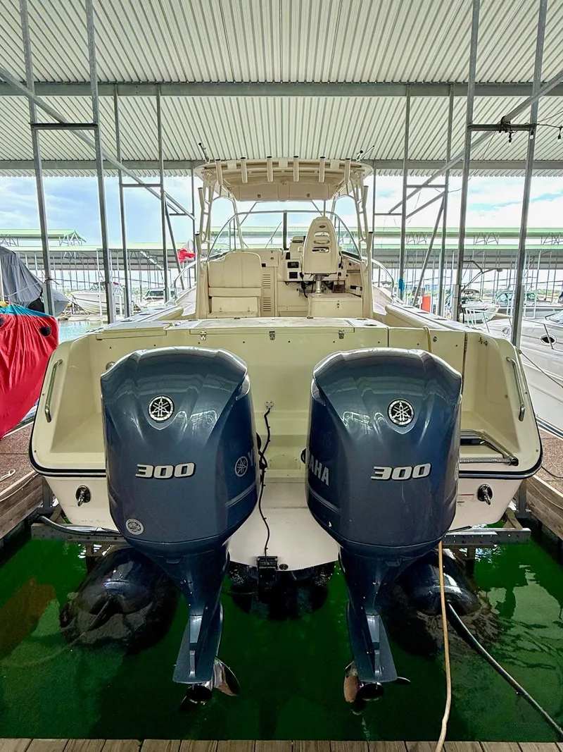 Slide: The Image of 2018 Grady-White Marlin 300 boat with twin Yamaha 300 engines in a covered dock. - 15