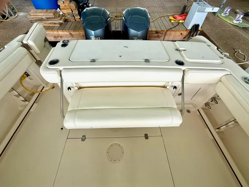 Slide: The Image of 2018 Grady-White Marlin 300 boat interior with seating and dual outboard engines. - 26