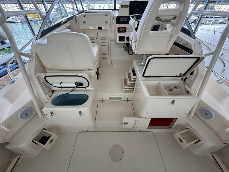 Slide: The Image of 2018 Grady-White Marlin 300 boat interior with helm, seating, and storage compartments. - 31