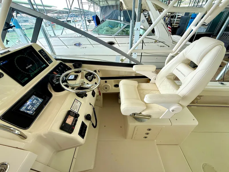 Slide: The Image of 2018 Grady-White Marlin 300 helm with modern controls and luxurious captain's chair. - 34