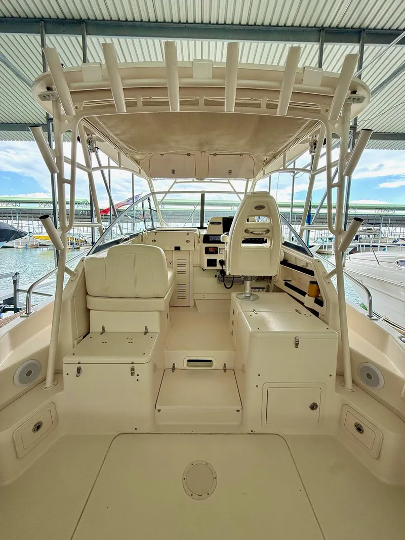 Slide: The Image of 2018 Grady-White Marlin 300 boat interior with helm and seating under a canopy. - 35