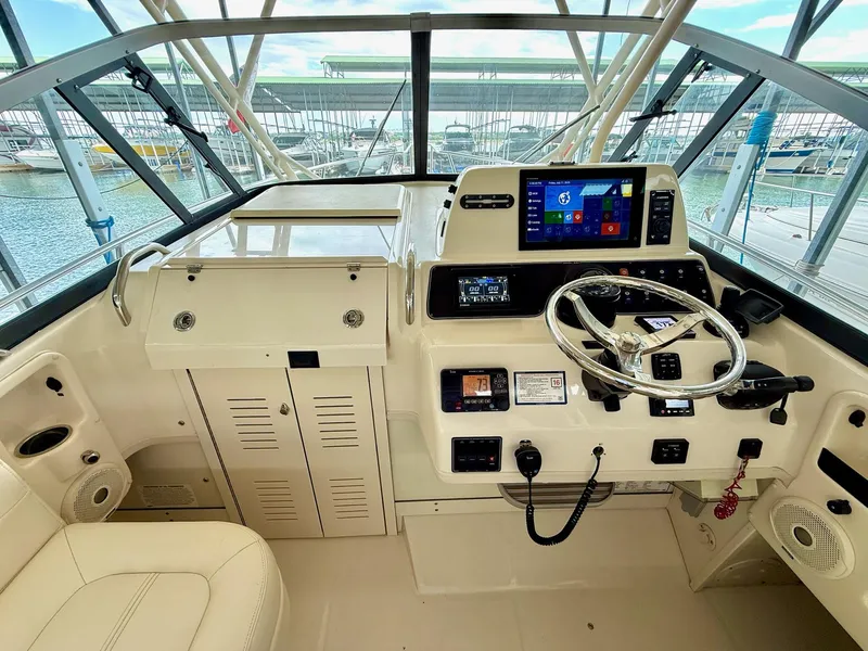 Slide: The Image of 2018 Grady-White Marlin 300 helm with modern controls and navigation system. - 36