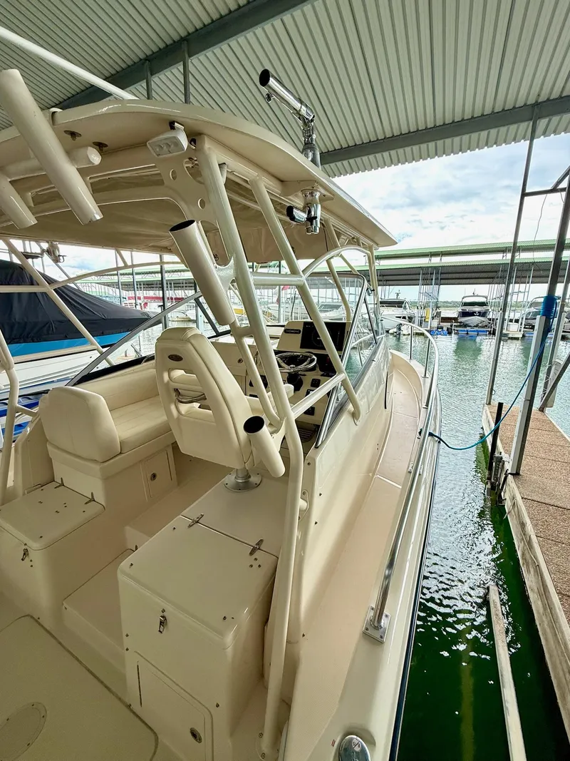 Slide: The Image of 2018 Grady-White Marlin 300 boat docked in a covered marina. - 43