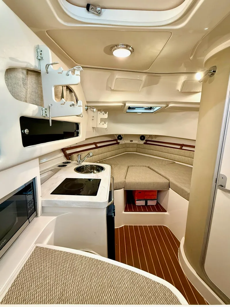 Slide: The Image of Interior of 2018 Grady-White Marlin 300 boat with kitchenette and seating area. - 46