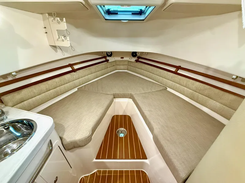 Slide: The Image of 2018 Grady-White Marlin 300 cabin interior with beige seating and wood accents. - 47