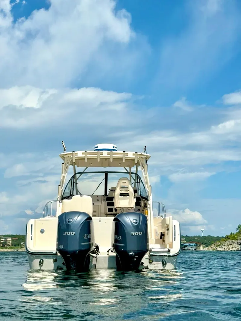 Slide: The Image of 2018 Grady-White Marlin 300 boat with twin Yamaha 300 engines on water. - 5