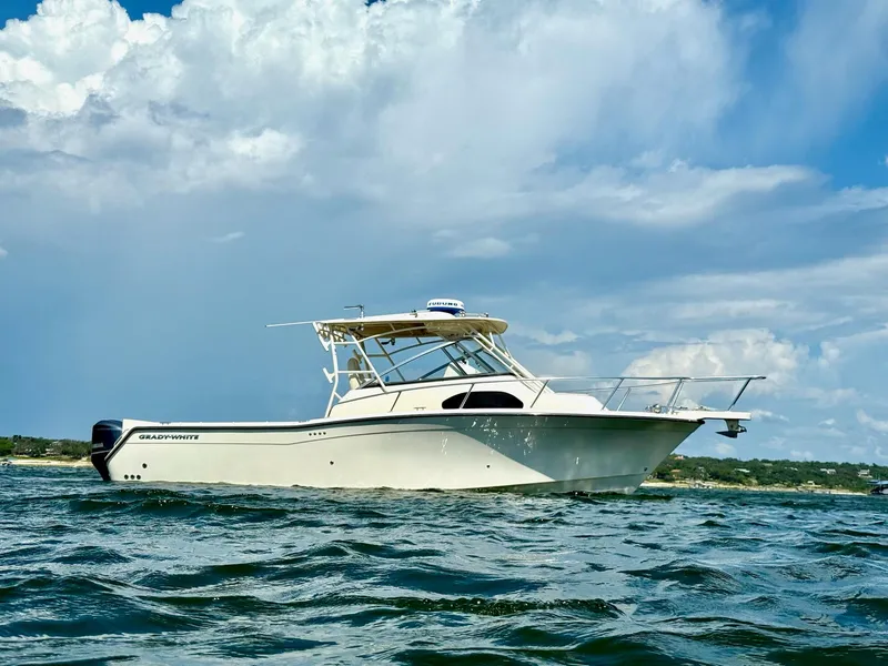 Slide: The Image of 2018 Grady-White Marlin 300 boat on water under cloudy sky. - 6