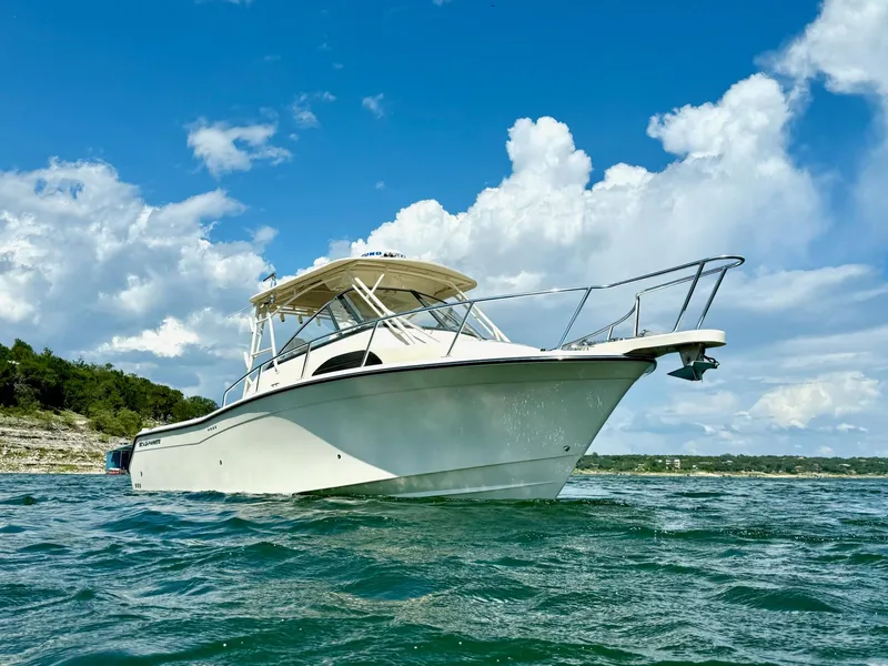 Slide: The Image of 2018 Grady-White Marlin 300 boat on water under blue sky and clouds. - 8
