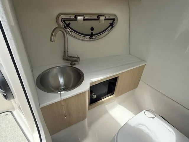 Slide: The Image of Compact bathroom in 2026 Regal LS6 boat with stainless steel sink and modern fixtures. - 14
