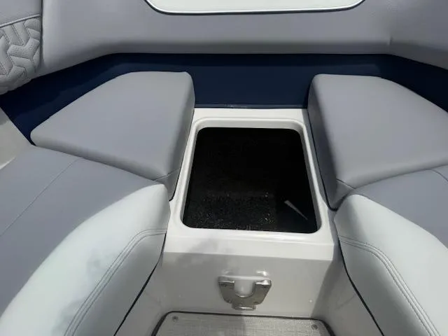 Slide: The Image of 2026 Regal LS6 boat interior with gray seating and storage compartment. - 19