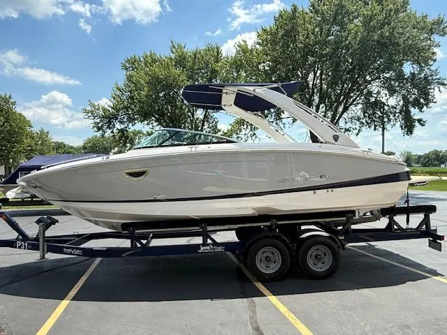 Slide: The Image of 2026 Regal LS6 boat on trailer, parked outdoors under a sunny sky. - 35