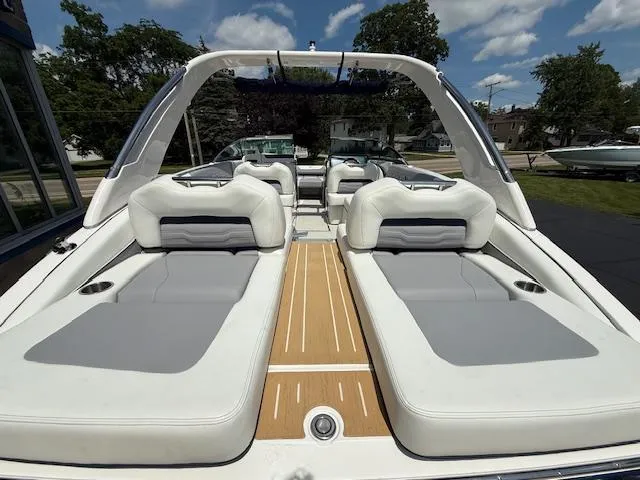 Slide: The Image of 2026 Regal LS6 boat interior with white and gray seating, wooden deck, and open-air design. - 5