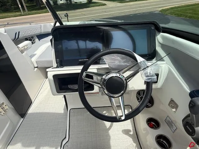 Slide: The Image of Steering wheel and dashboard of 2026 Regal LS6 boat, featuring modern controls and design. - 9