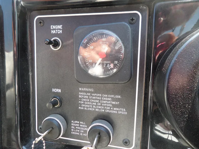 Slide: The Image of Control panel of 1989 Formula F272 SR 1 boat with engine hour meter and warning labels. - 13