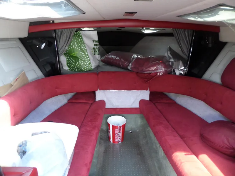 Slide: The Image of Interior of 1989 Formula F272 SR 1 boat with red seating and storage items. - 14