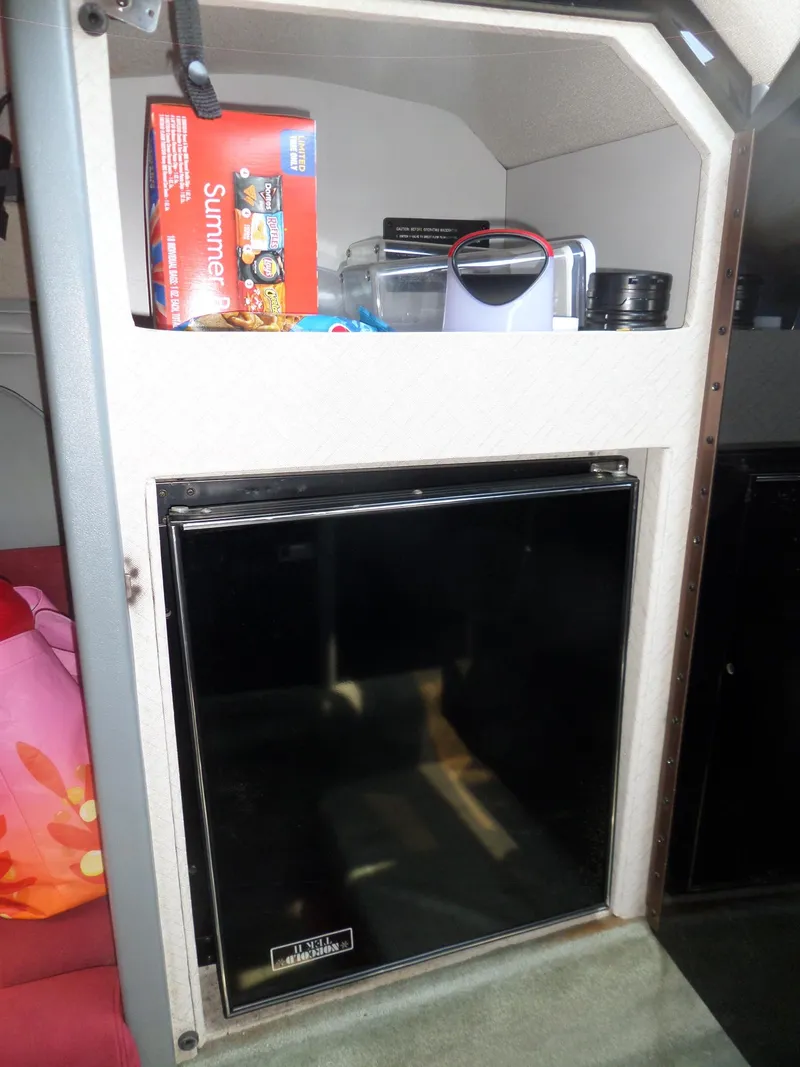 Slide: The Image of 1989 Formula F272 SR 1 cabin with mini fridge and storage shelf. - 19