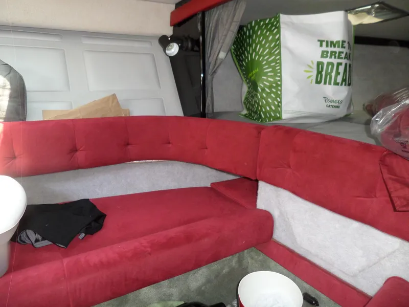 Slide: The Image of Interior of 1989 Formula F272 SR 1 boat with red seating and storage area. - 21