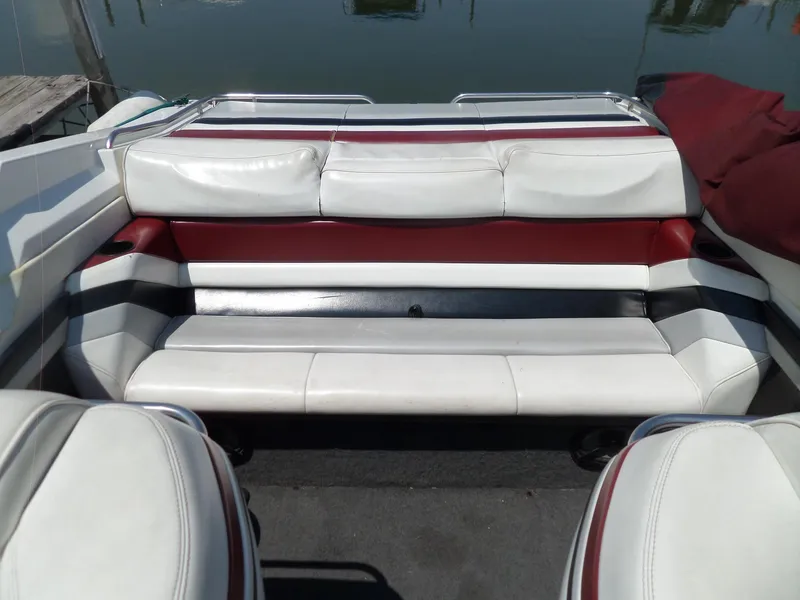 Slide: The Image of 1989 Formula F272 SR 1 boat interior with white and red seating, docked by water. - 24