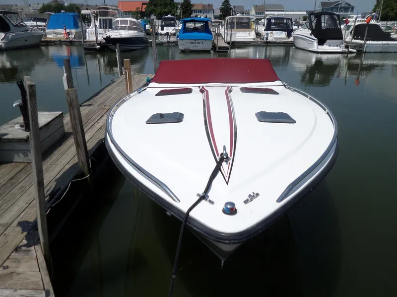 Slide: The Image of 1989 Formula F272 SR 1 boat docked at marina, featuring sleek design and red accents. - 3