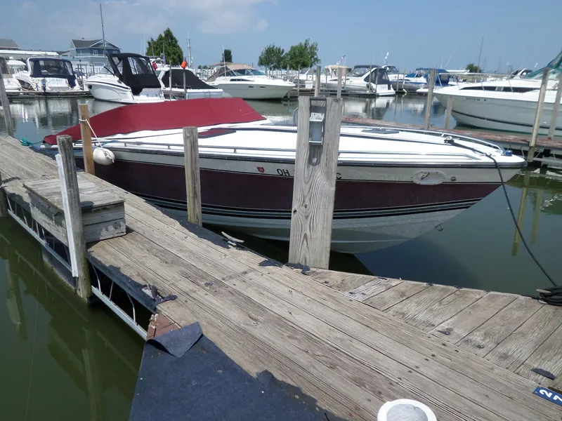 Slide: The Image of 1989 Formula F272 SR 1 boat docked at a marina with other vessels. - 4