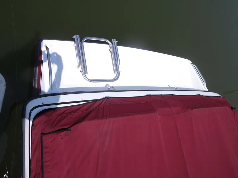 Slide: The Image of 1989 Formula F272 SR 1 boat with maroon cover on water. - 5