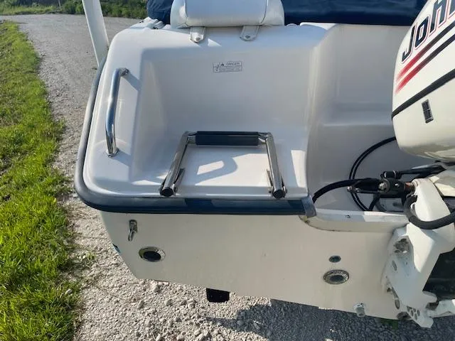 Slide: The Image of 2004 Sea Hunt Triton 186 boat with Johnson outboard motor and swim platform ladder. - 10