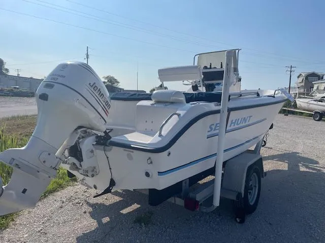 Slide: The Image of 2004 Sea Hunt Triton 186 boat with Johnson outboard motor on a trailer. - 2