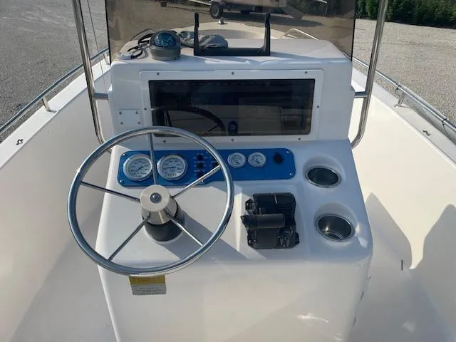 Slide: The Image of 2004 Sea Hunt Triton 186 boat dashboard with steering wheel and gauges. - 5