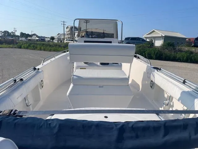 Slide: The Image of 2004 Sea Hunt Triton 186 boat interior with seating and console, parked outdoors. - 6