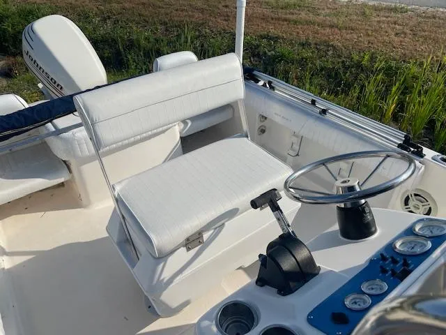 Slide: The Image of 2004 Sea Hunt Triton 186 boat interior with steering wheel and seating. - 7