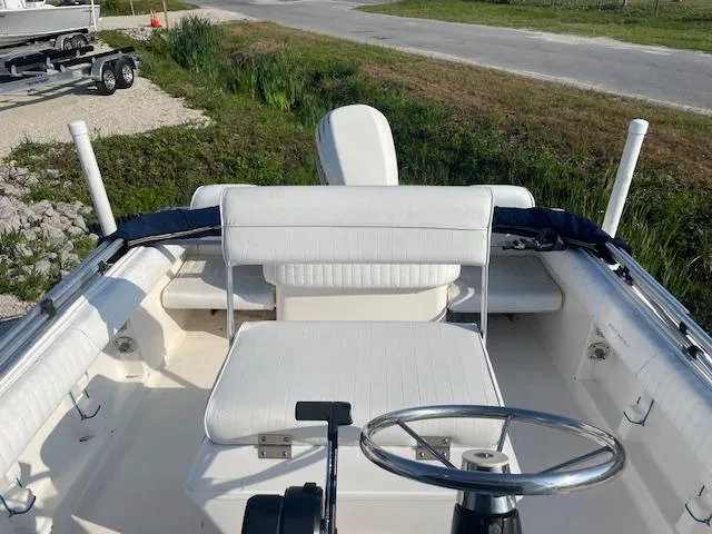 Slide: The Image of 2004 Sea Hunt Triton 186 boat interior with white seating and steering wheel. - 8