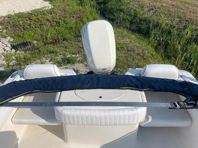 Slide: The Image of 2004 Sea Hunt Triton 186 boat interior with seating and motor, outdoors. - 9