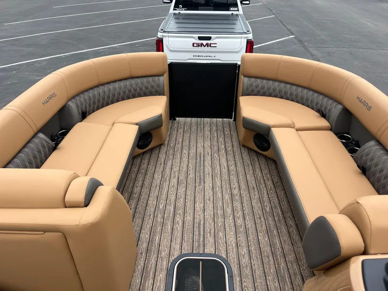 Slide: The Image of 2026 Harris Cruiser 230 boat interior with tan seating and wood-patterned flooring. - 4