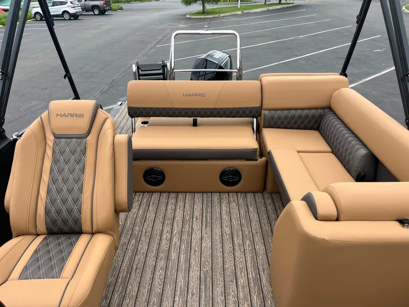 Slide: The Image of Luxurious interior of 2026 Harris Cruiser 230 pontoon boat with tan and gray seating. - 5