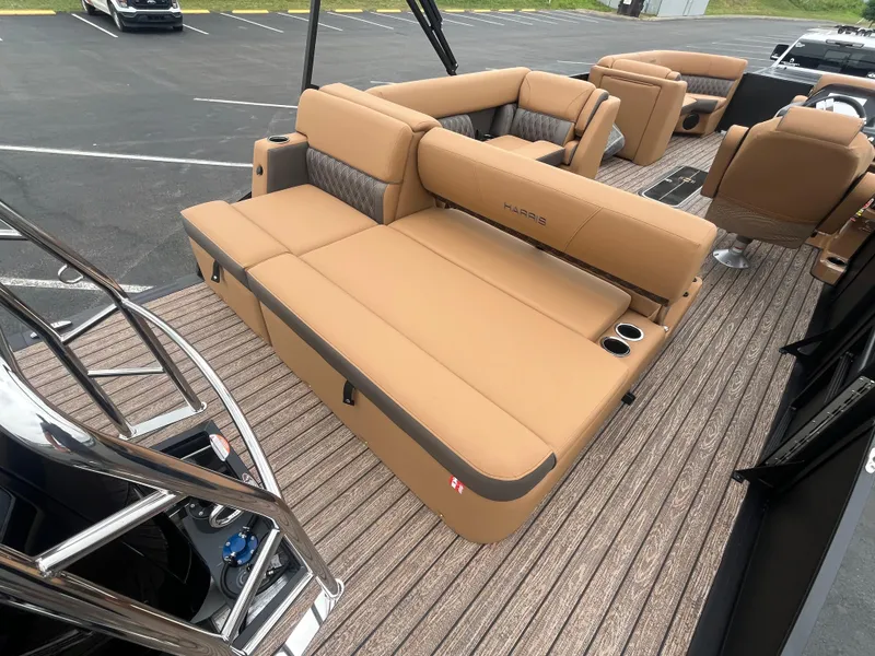 Slide: The Image of 2026 Harris Cruiser 230 boat interior with tan seating and wood-style flooring. - 7