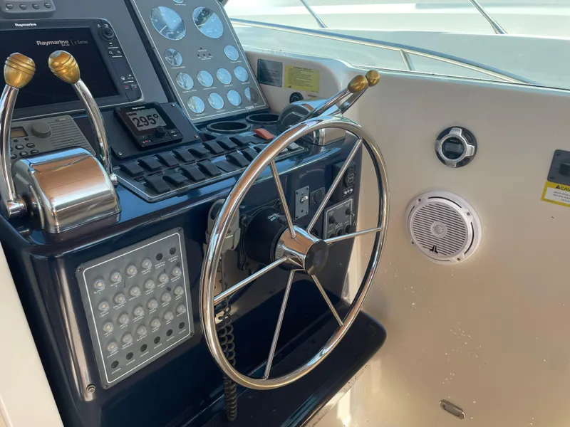 Slide: The Image of 1998 Tiara Yachts 3500 Open helm with steering wheel and navigation controls. - 10