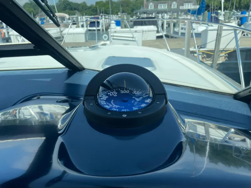 Slide: The Image of Compass on 1998 Tiara Yachts 3500 Open, docked at marina. - 13